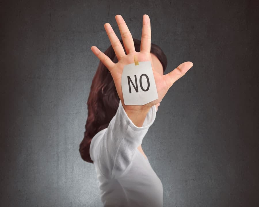 Side view of a woman showing NO note on her hand